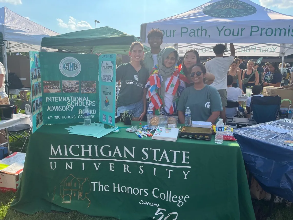 Students at a Michigan State Honors College International Scholars Advisory Board outreach table